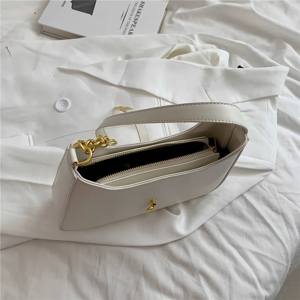 Bolsa Ágatha estilo baguete, elegante e moderna. Compacta, feita em material sintético de alta qualidade, combina com looks casuais e refinados.