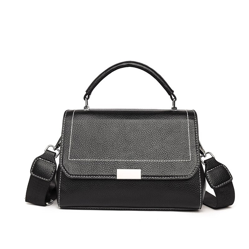 Bolsa Laura em couro legítimo, compacta, elegante e versátil. Com alça ajustável, zíper, botão magnético e divisórias para praticidade no dia a dia.