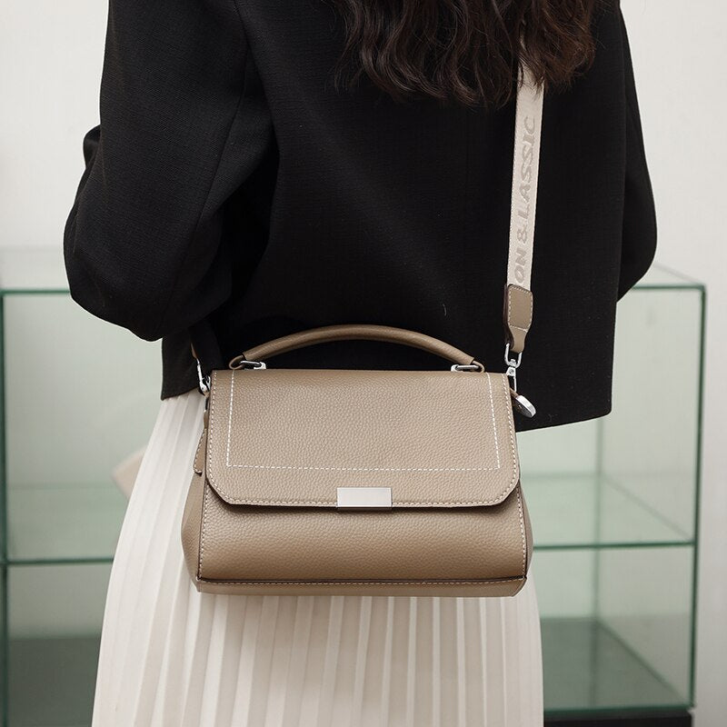 Bolsa Laura em couro legítimo, compacta, elegante e versátil. Com alça ajustável, zíper, botão magnético e divisórias para praticidade no dia a dia.