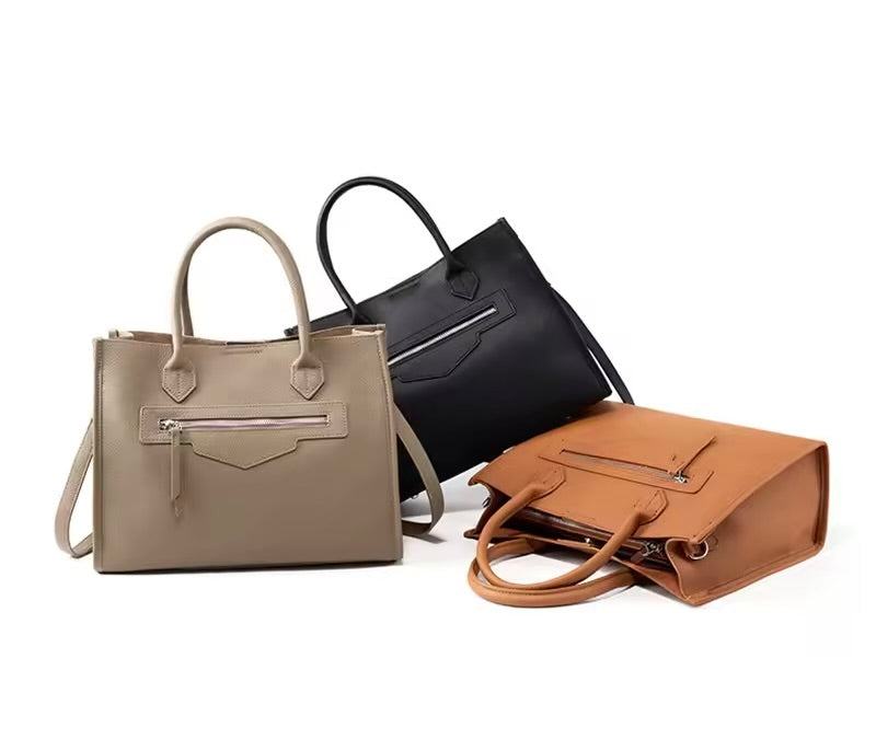 Bolsa Olívia em couro legítimo, tote grande e elegante. Espaçosa, com divisórias, fecho duplo e alças para usar na mão ou no modelo transversal.