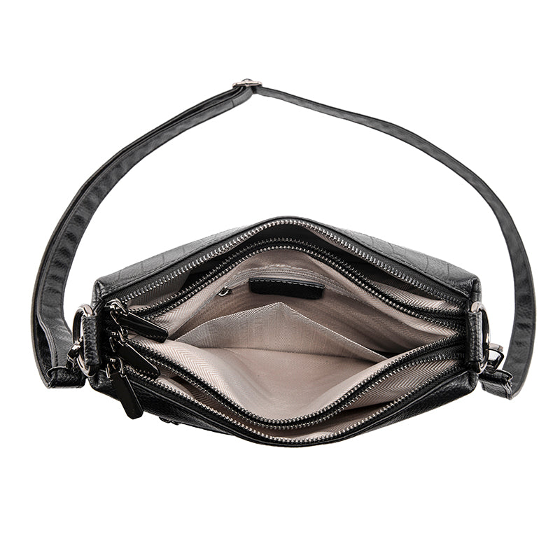 Bolsa Alicia em couro legítimo, compacta e funcional. Design minimalista, alça regulável e espaço ideal para itens essenciais com praticidade e estilo.