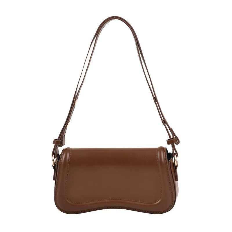 Bolsa Emily estilo baguete com design ondulado. Compacta, elegante e versátil, em material sintético com botão magnético e espaço ideal para o dia a dia.