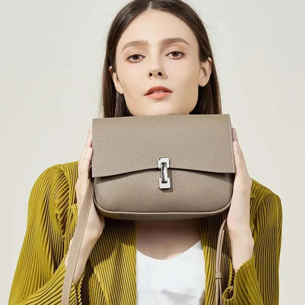 Bolsa Bruna em couro legítimo, compacta, elegante e durável. Modelo transversal com divisórias internas para manter seus itens organizados com estilo.